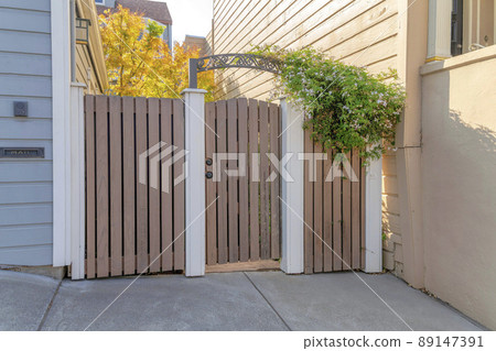 Wooden gate and fence with white concrete columns at San Francisco, California Wooden gate and fence with white concrete columns at San Francisco, California 89147391