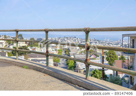 Rusty metal bar handrails with a view below of the neighborhood in San Francisco, California Rusty metal bar handrails with a view below of the neighborhood in San Francisco, California 89147406