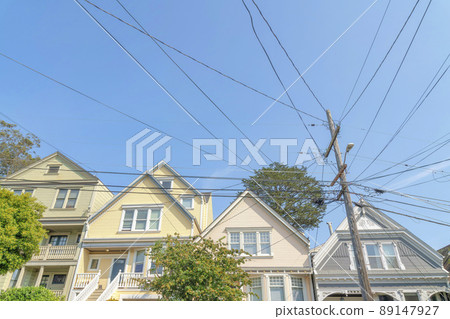 Electrical post at the front of suburban houses in a low angle view at San Francisco, California 89147927
