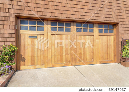 Wooden bi-fold garage doors with glass panel at San Francisco, California Wooden bi-fold garage doors with glass panel at San Francisco, California 89147987