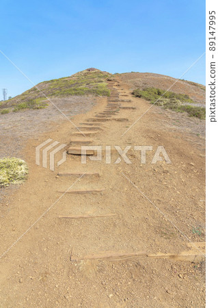 Mountain trail with wooden steps on the slope at the view from Twin Peaks in San Francisco, CA 89147995