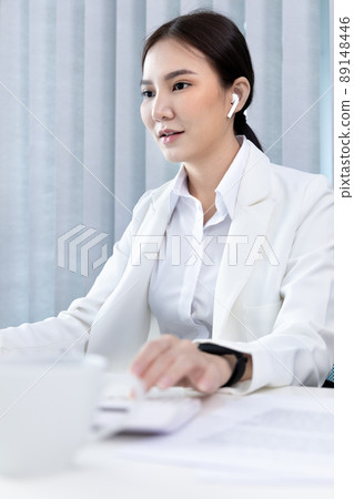 Businesswoman presses a calculator to calculate earnings and analyze company earnings in his private office, Information in finance and accounting, Company performance and revenue. 89148446