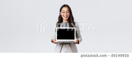Business, finance and employment, female successful entrepreneurs concept. Enthusiastic businesswoman in suit and glasses showing presentation, demonstrate her project on laptop screen Business, finance and employment, female successful entrepreneurs concept. Enthusiastic businesswoman in suit and glasses showing presentation, demonstrate her project on laptop screen 89149938