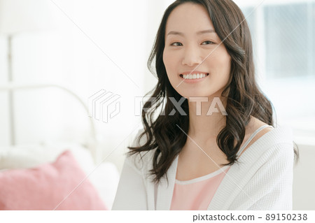 A young woman relaxing at her accommodation 89150238