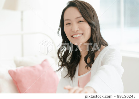 A young woman relaxing at her accommodation A young woman relaxing at her accommodation 89150243
