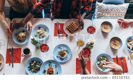People are sitting at a table and eating. Top view People are sitting at a table and eating. Top view 89150781