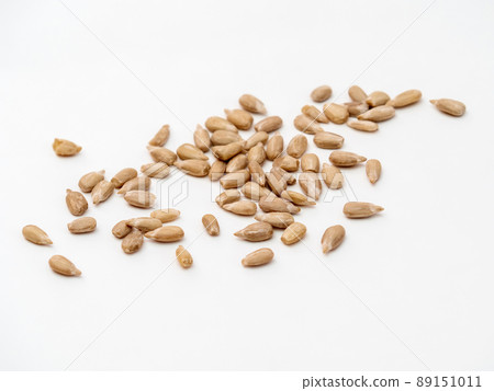 Handful peeled sunflower seeds isolated on white background. Close-up Handful peeled sunflower seeds isolated on white background. Close-up 89151011