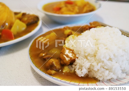 The rice is drizzled with curry sauce and curry chicken nuggets The rice is drizzled with curry sauce and curry chicken nuggets 89153550