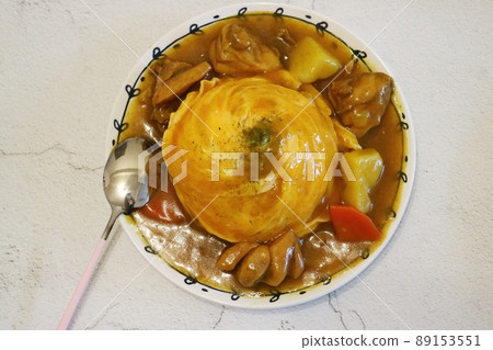 Yellow omelette rice and full of curry sauce on a white plate Curry Rice 89153551