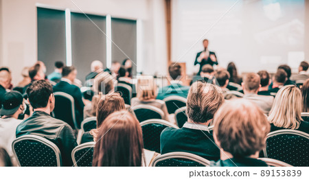 Speaker giving a talk in conference hall at business event. Rear view of unrecognizable people in audience at the conference hall. Business and entrepreneurship concept. Speaker giving a talk in conference hall at business event. Rear view of unrecognizable people in audience at the conference hall. Business and entrepreneurship concept. 89153839