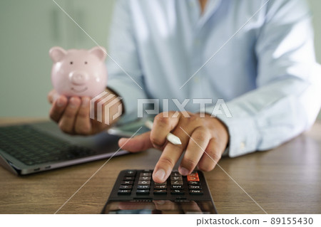 businessman working on desk office finance accounting saving money Piggy bank with business 89155430