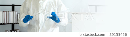 Epidemiological researchers in virus protective clothing holding inoculating needle and chemical petri dish. COVID-19 testing process in a laboratory. Epidemiological researchers in virus protective clothing holding inoculating needle and chemical petri dish. COVID-19 testing process in a laboratory. 89155436