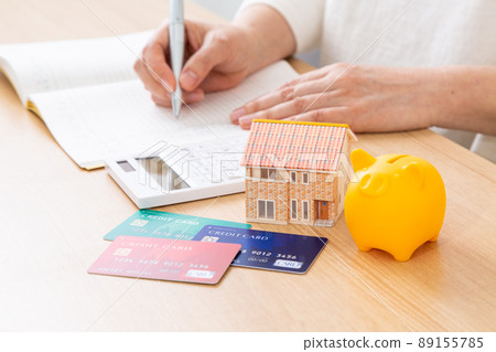 Middle woman keeping a household account book 89155785