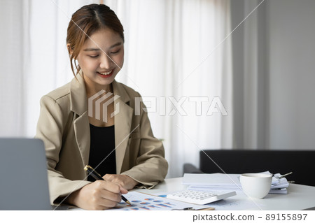 Charming female accountant working in modern office. Charming female accountant working in modern office. 89155897