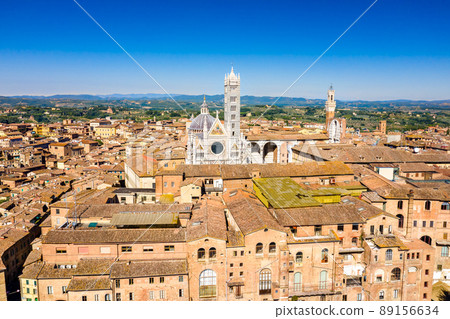 Aerial view of Siena with the Cathedral and the Mangia Tower. UNESCO world heritage in Tuscany, Italy Aerial view of Siena with the Cathedral and the Mangia Tower. UNESCO world heritage in Tuscany, Italy 89156634