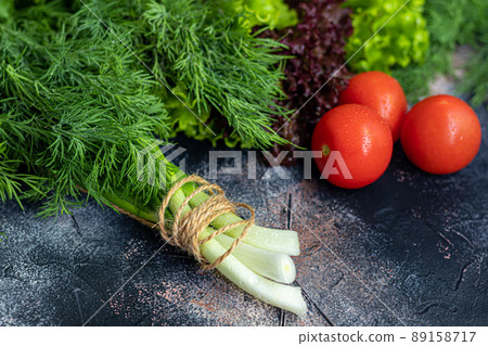 Fresh vegetables for salad. Tomatoes and lettuce, cucumbers with zucchini and cabbage with dill. Spring harvest, benefits and vitamins. On a dark background. Fresh vegetables for salad. Tomatoes and lettuce, cucumbers with zucchini and cabbage with dill. Spring harvest, benefits and vitamins. On a dark background. 89158717