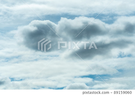 White and gray fluffy clouds on blue sky. Soft touch feeling like cotton. White puffy cloudscape. Beauty in nature. Close-up white clouds texture background. Cloudy sky. Background for tranquility. 89159060