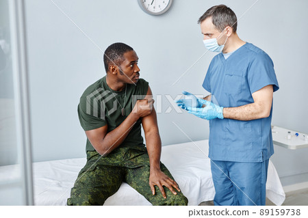 Nurse Giving Recommendations To Young Man 89159738