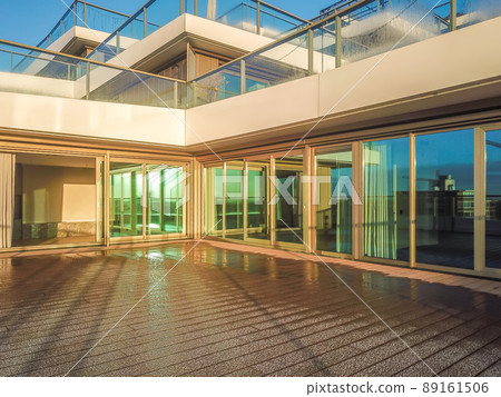 The entrance to an unusual residential building with a solid glass wall and an entrance door The entrance to an unusual residential building with a solid glass wall and an entrance door 89161506