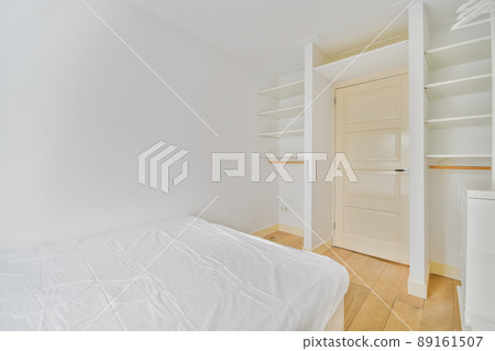 Attractive small bedroom with a soft bed and white walls Attractive small bedroom with a soft bed and white walls 89161507