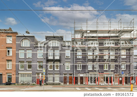 Residential brick houses in purple color and repair work nearby Residential brick houses in purple color and repair work nearby 89161572