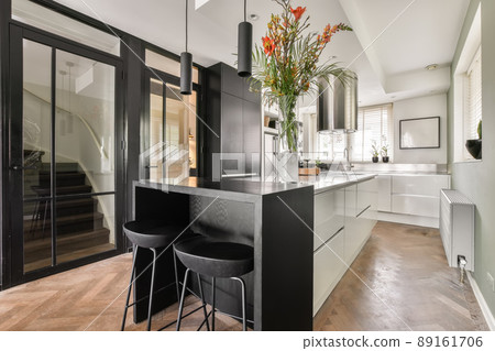 Modern design of a spacious kitchen with appropriate equipment in a cozy house 89161706