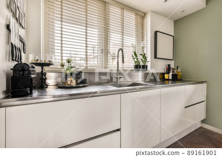 Modern design of a spacious kitchen with appropriate equipment in a cozy house 89161901