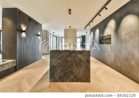 A spacious room in a minimalist style with a marble counter and a built-in sink in a modern house A spacious room in a minimalist style with a marble counter and a built-in sink in a modern house 89162126