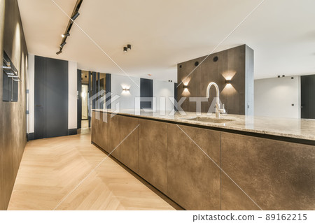 A spacious room in a minimalist style with a marble counter and a built-in sink in a modern house 89162215