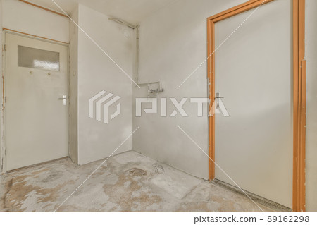 A small bright corridor with an entrance to several rooms in a small residential building A small bright corridor with an entrance to several rooms in a small residential building 89162298