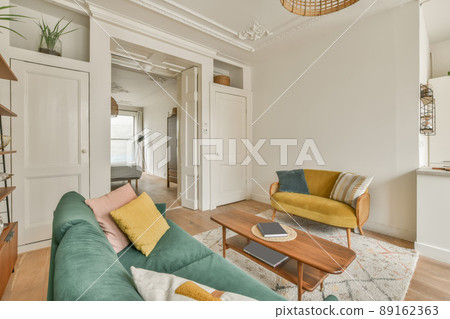 Rich interior of the living room of a modern house with a sofa and carpet on the floor 89162363