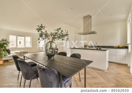 The interior of the kitchen and dining area in a modern style in a cozy apartment The interior of the kitchen and dining area in a modern style in a cozy apartment 89162650