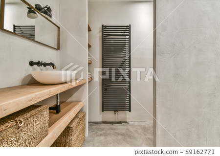 Bathroom interior with a bowl-shaped sink and a rectangular mirror in a modern house 89162771