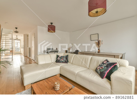 The interior of a spacious living room in an open design with a big sofa in a cozy house The interior of a spacious living room in an open design with a big sofa in a cozy house 89162881
