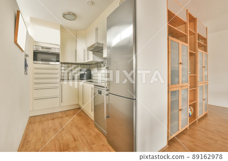 A modest small minimalistic kitchen with appropriate equipment in a cozy house A modest small minimalistic kitchen with appropriate equipment in a cozy house 89162978
