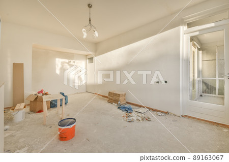 A spacious room under renovation in bright colors with building materials 89163067