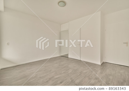 A small empty room with mirror and several doors outside in a modern house 89163343