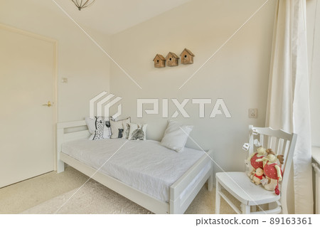 The interior of a bedroom with a small bed and a carpet on the floor in a modern house 89163361