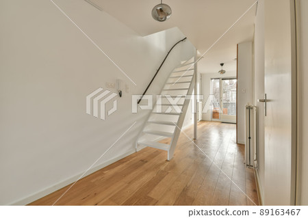 Corridor leading to a living room with a parquet floor and access to the balcony in a cozy house 89163467