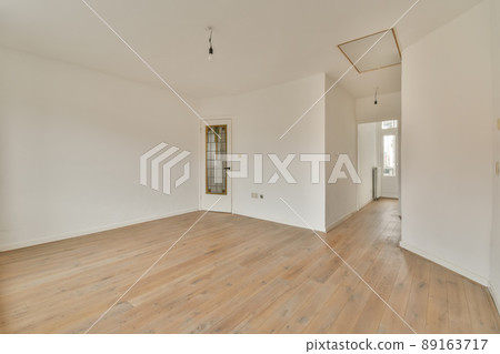 A spacious empty room with an angular interior in white in a modern house A spacious empty room with an angular interior in white in a modern house 89163717