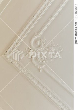A pattern made on the white ceiling of a modern residential building A pattern made on the white ceiling of a modern residential building 89163885