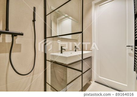 Shower stall and double sink in a modern bathroom in a minimalist style 89164016