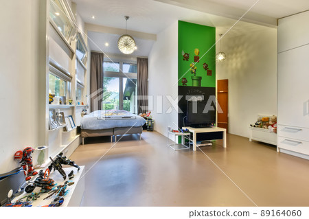 Large children's room with a rich interior, with a study place, a recreation and entertainment area Large children's room with a rich interior, with a study place, a recreation and entertainment area 89164060