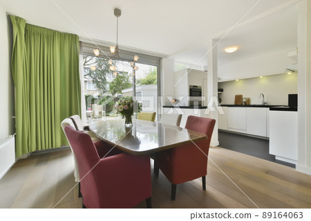 Dining area with a large table, bright chairs and bright design Dining area with a large table, bright chairs and bright design 89164063