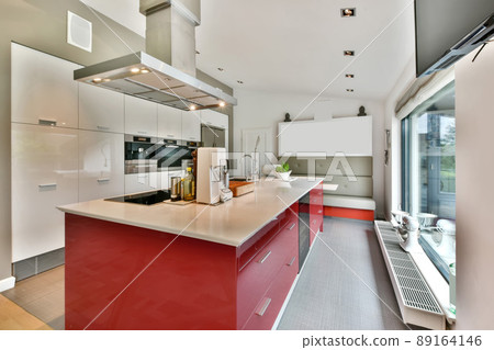 The interior of an open rich kitchen fully equipped with modern appliances 89164146