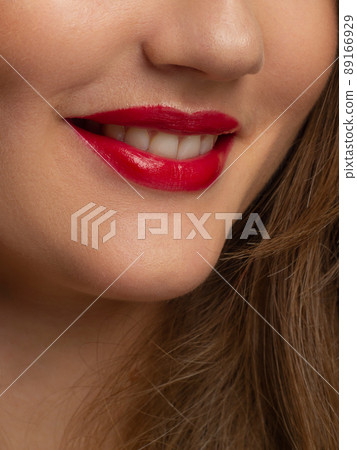 Close-up shot of sexy woman's lips with red lipstick and clean skin. Beautiful spa portrait with a snow-white smile. Spa and cosmetics, dentistry and cosmetology Close-up shot of sexy woman's lips with red lipstick and clean skin. Beautiful spa portrait with a snow-white smile. Spa and cosmetics, dentistry and cosmetology 89166929
