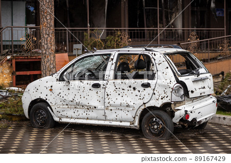 Irpin, Kyev region  Ukraine - 09.04.2022: Cities of Ukraine after the Russian occupation. On the streets of Irpin. Shot cars. Irpin, Bucha, Gostomel. 89167429
