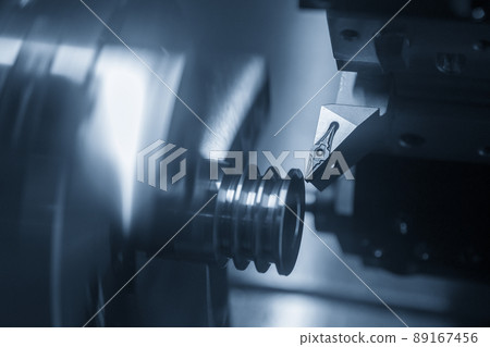 The  CNC lathe machine groove cutting the metal pulley parts. 89167456