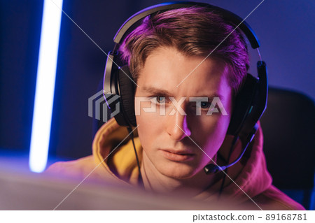 Guy cyber sportsman streaming while playing shooting game 89168781