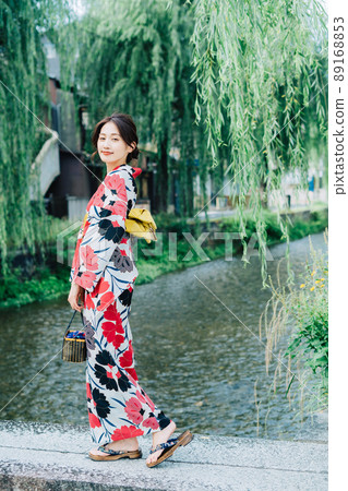 A woman in a yukata on the street in Kyoto 89168853